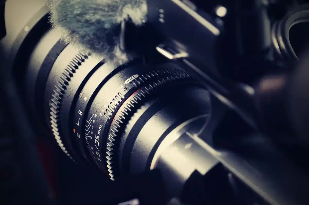 Ultra-low-resolution camera lens close-up, 1-megapixel sensor macro, circuit board components blurred behind, warm technical lighting, shallow depth of field