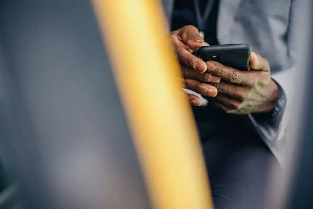 Close-up of smartphone screen showing encrypted message interface with lock icons and data visualization of encrypted traffic flowing through secure channels