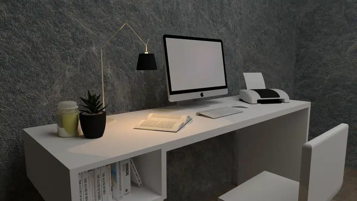 A sleek modern computer setup with a compact Mac mini and a Mac Studio tower side by side on a minimalist desk, displaying the new M6 and M5 Ultra chips' power in a professional environment