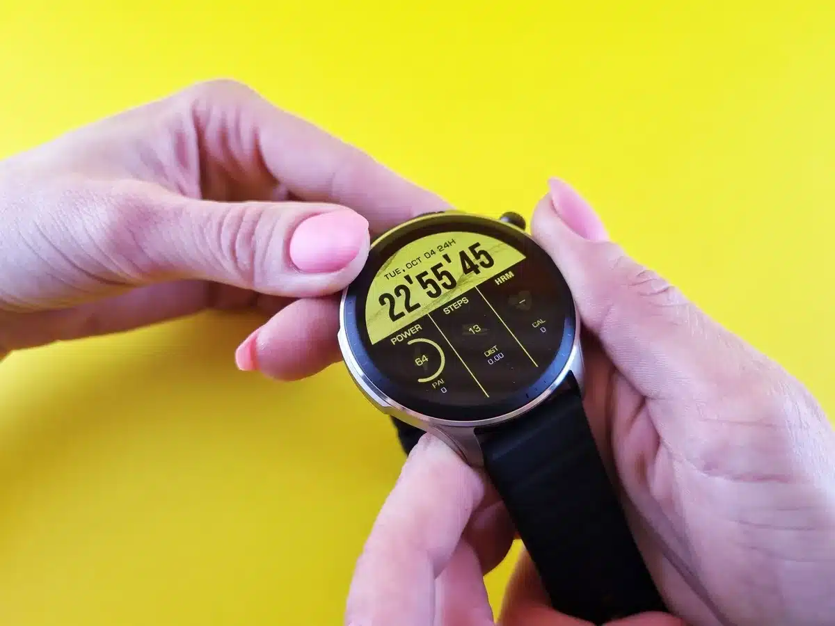 A split-screen comparison showing a smartwatch with AMOLED screen on one side and a traditional sports watch on the other, both resting on a minimalist surface, emphasizing the modern bright display technology