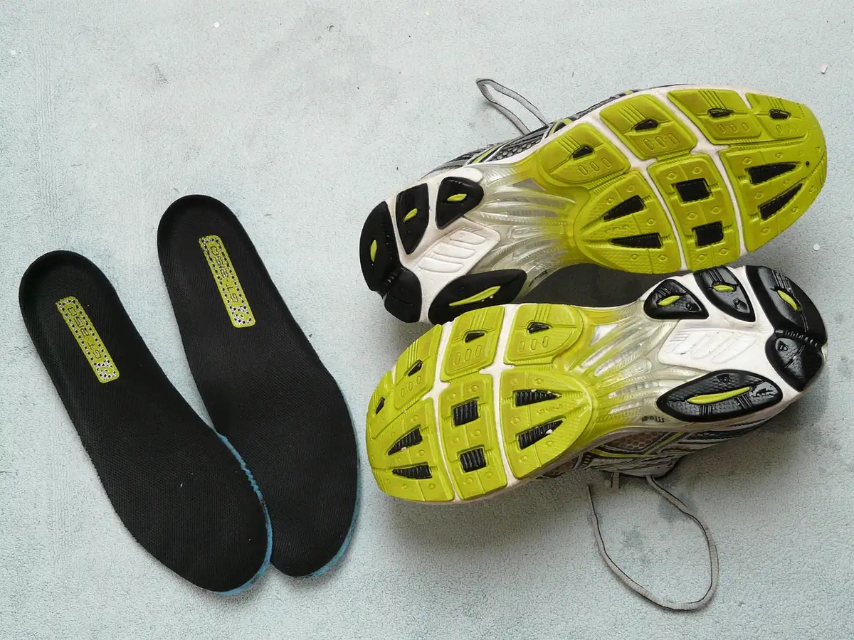 Plantilla extraíble con almohadilla de gel junto a unas zapatillas