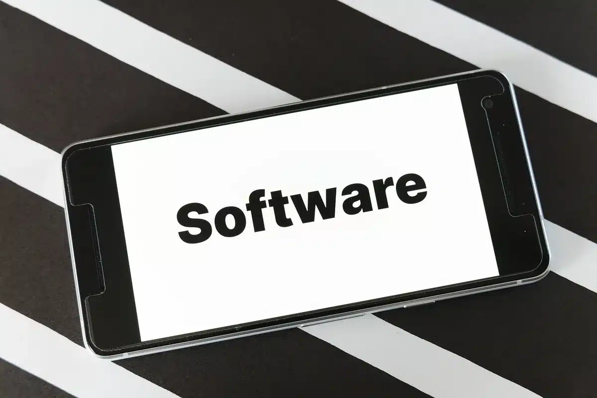 anonymous hands holding an unbranded tablet showing a software update progress bar, screen glow on fingers, indistinct background