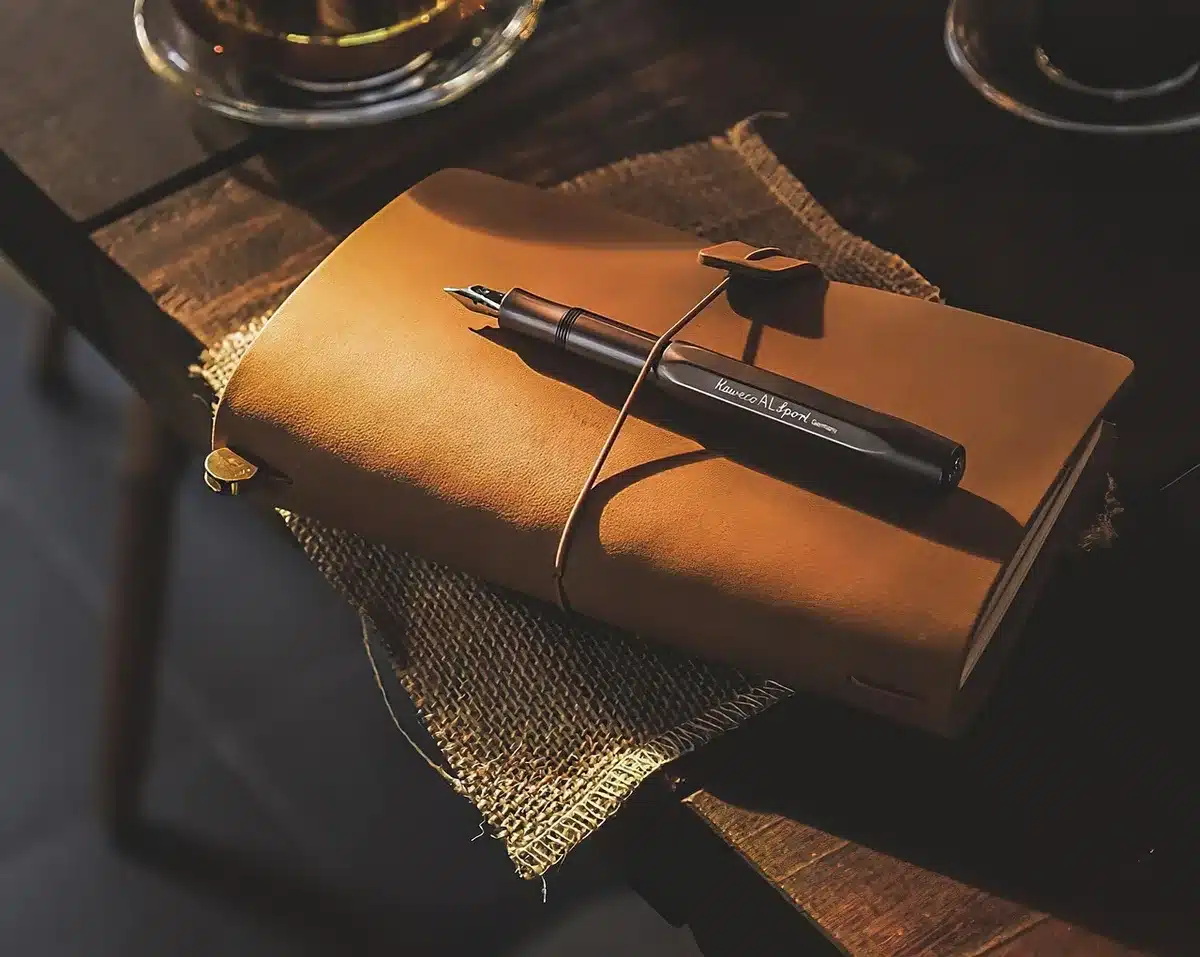 anonymous hands adjusting an elegant watch on a desk, no brand visible