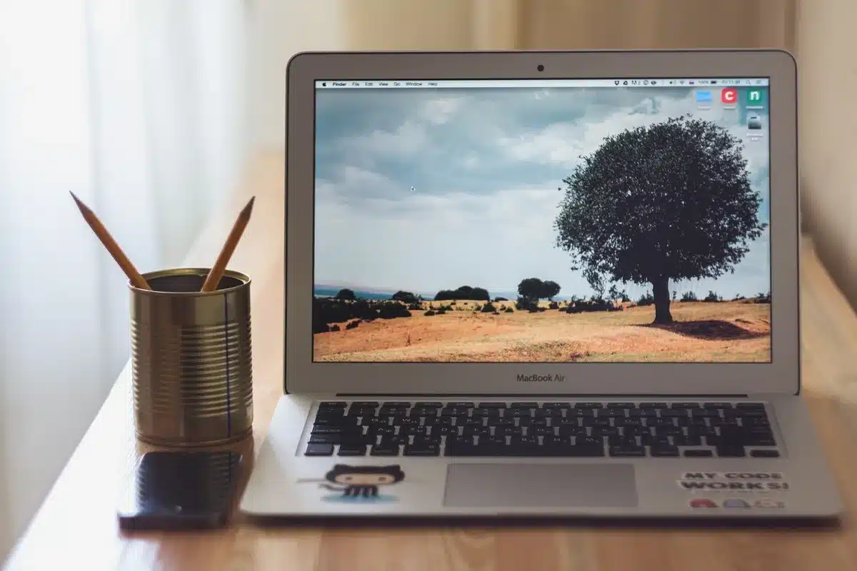 A sleek silver MacBook Air laptop displayed on a clean desk surface with soft natural lighting, showing the M5 chip era design with minimal reflections and no visible branding
