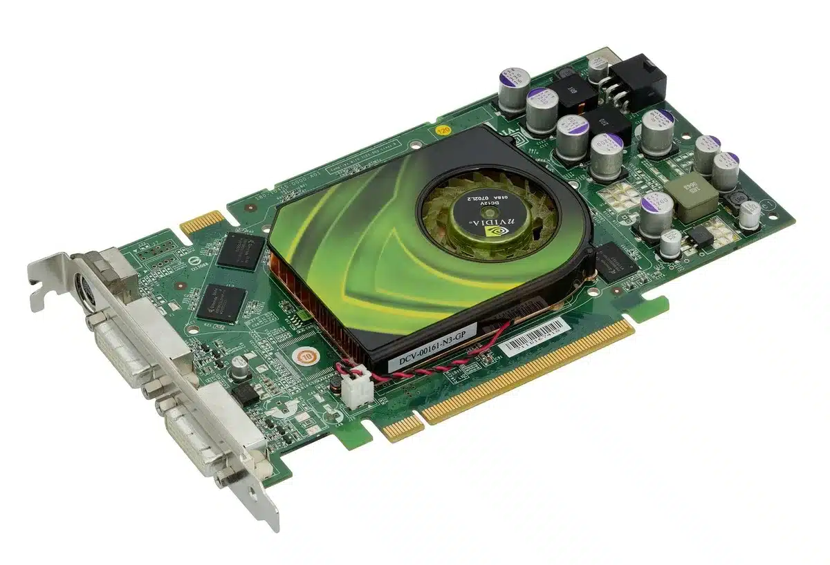 A close-up of a graphics card's cooling system with NVIDIA branding blurred, set against a dark workstation environment with soft blue accent lighting