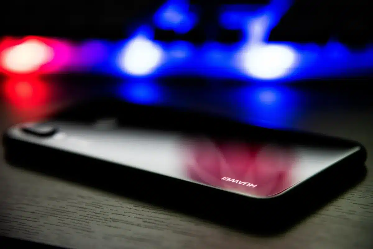 Two flagship smartphones side by side on a minimalist surface, one larger with a premium finish, displaying high refresh rate AMOLED screens with 185 Hz, premium materials visible on the frames and backs.