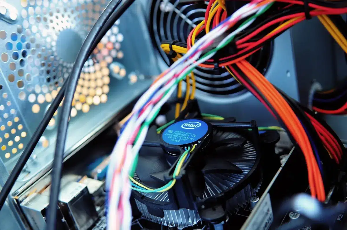 A modern PC tower with internal components visible, glowing CPU socket highlighted under blue light, representing system performance optimization