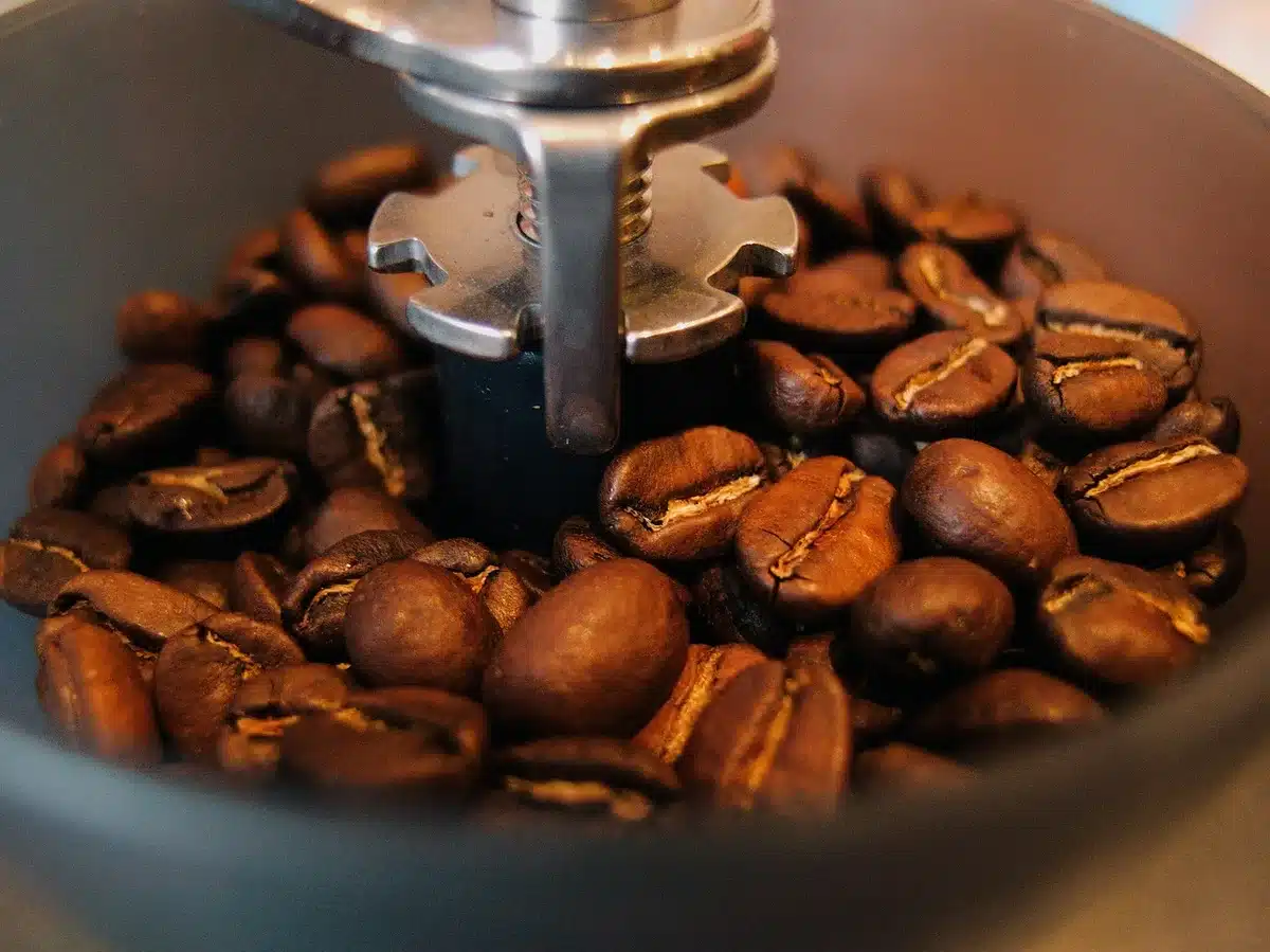 Molinillo integrado con granos de café junto a una tolva