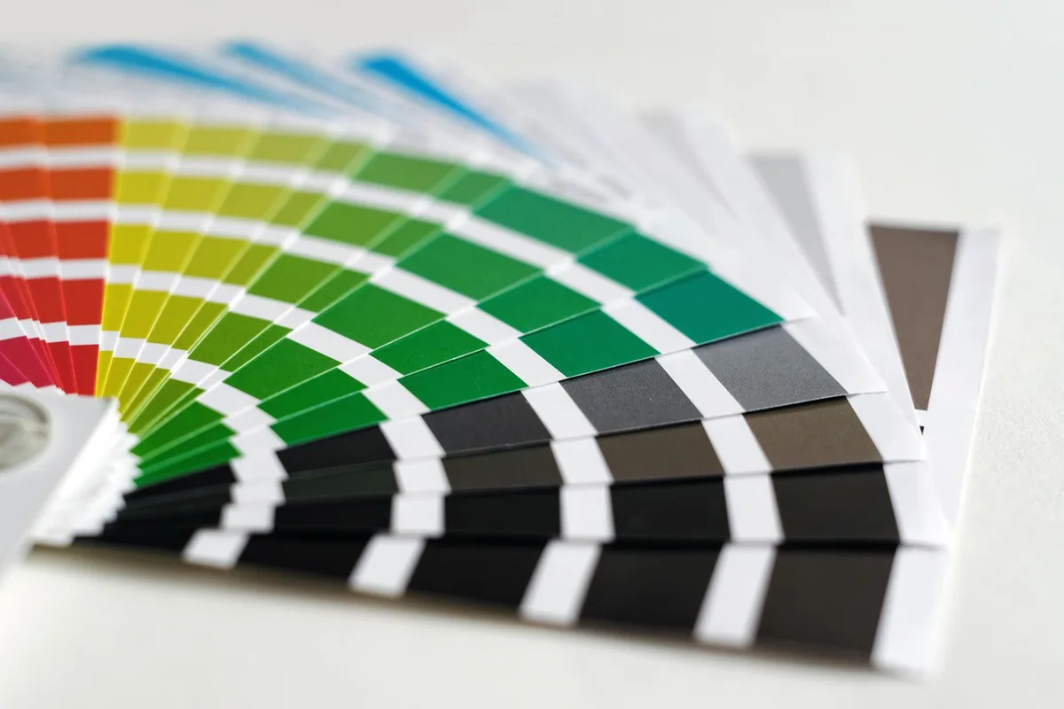 A selection of three anonymous unbranded devices laid out on fabric swatches in matching muted colors suggesting product colorways