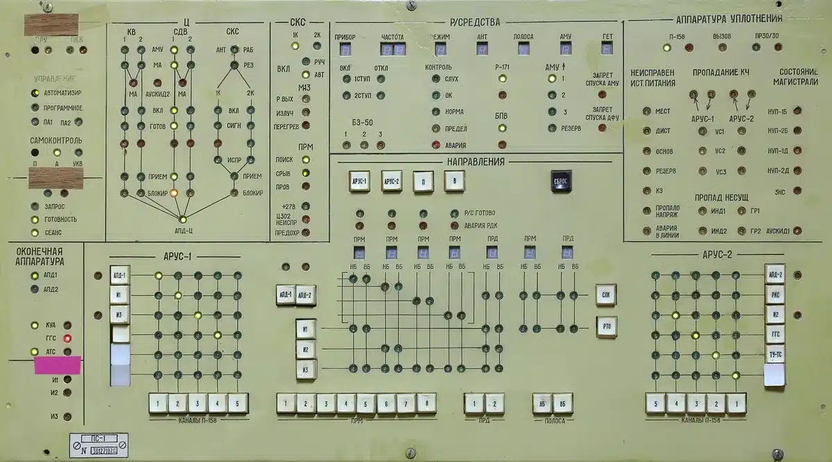 empty workstation desk with an anonymous laptop showing system monitoring graphs