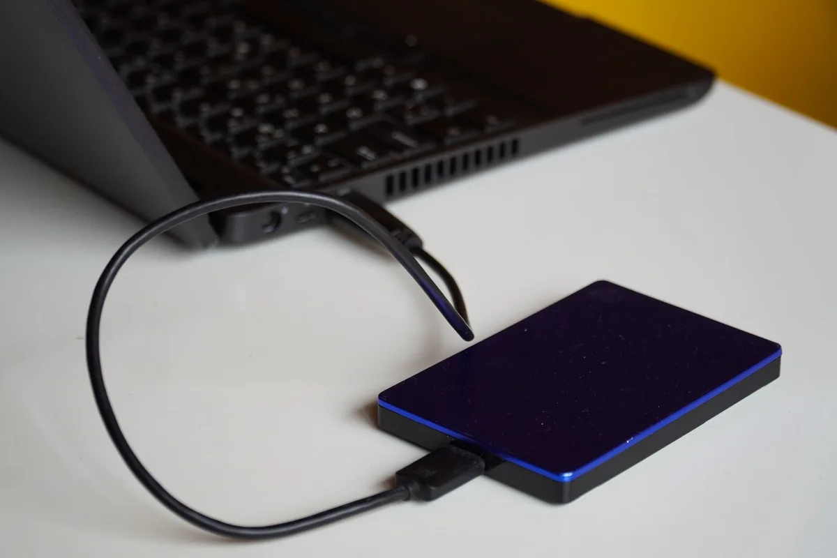 anonymous close-up of a generic SSD drive on a workbench with tools nearby