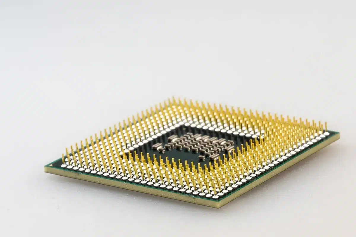 A close-up symbolic shot of a generic silicon wafer and a small circuit board with no logos, lit by a cool LED glow