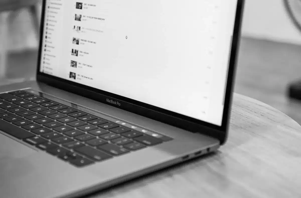 empty aluminium laptop on a clean table, soft daylight, no logos or text