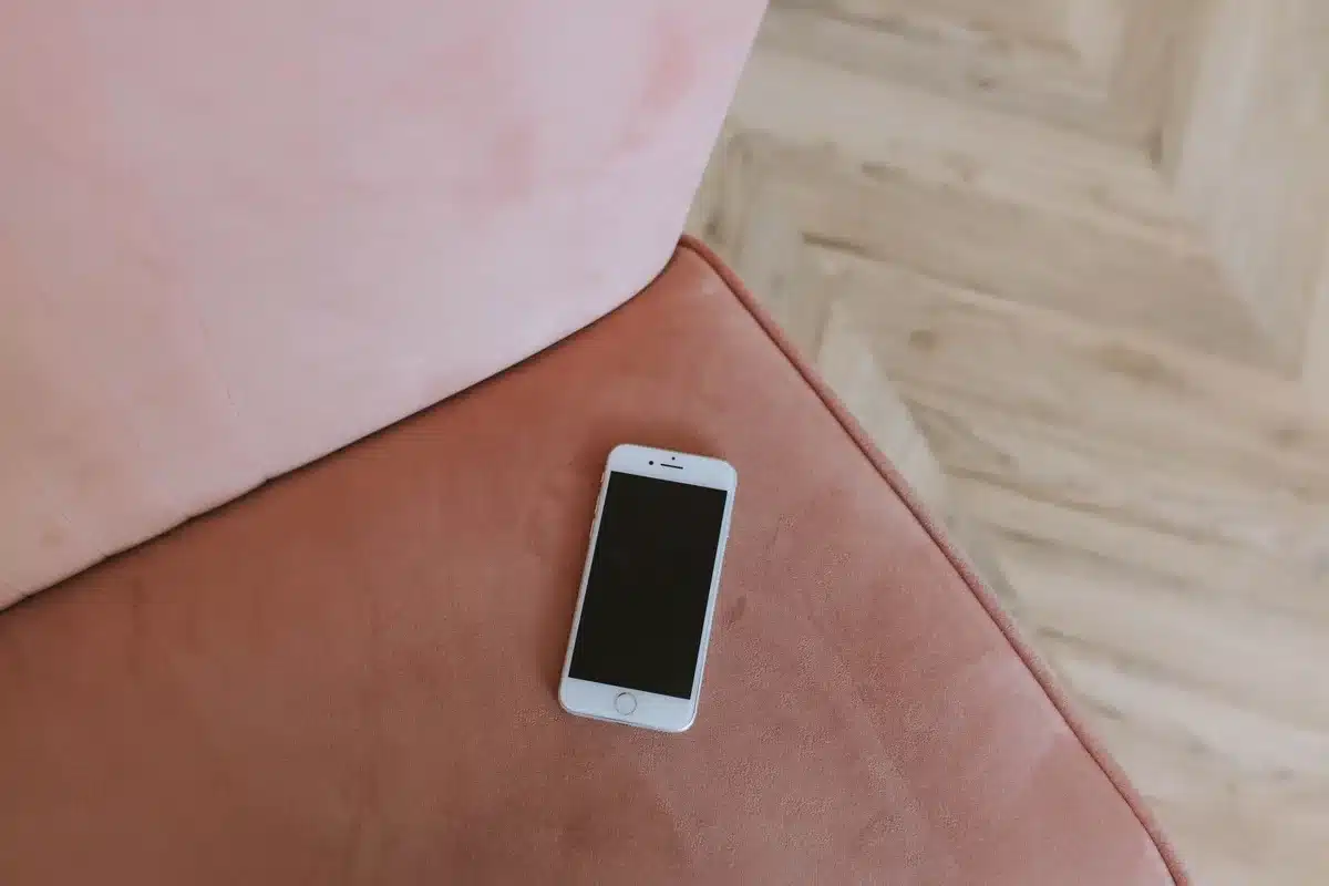 Anonymous hands holding an unbranded phone showing a software update progress bar on-screen, indoors