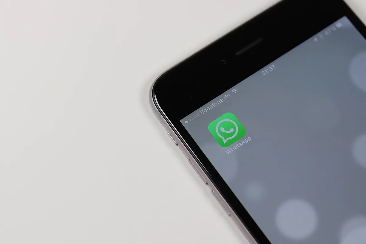 Close-up of a generic smartphone screen showing a messaging app with sending spinner icon, no brand visible